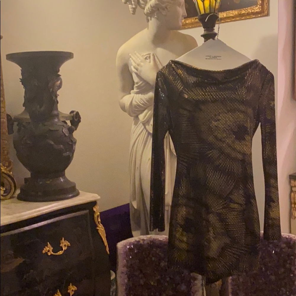 This is a gold and black mini dress.